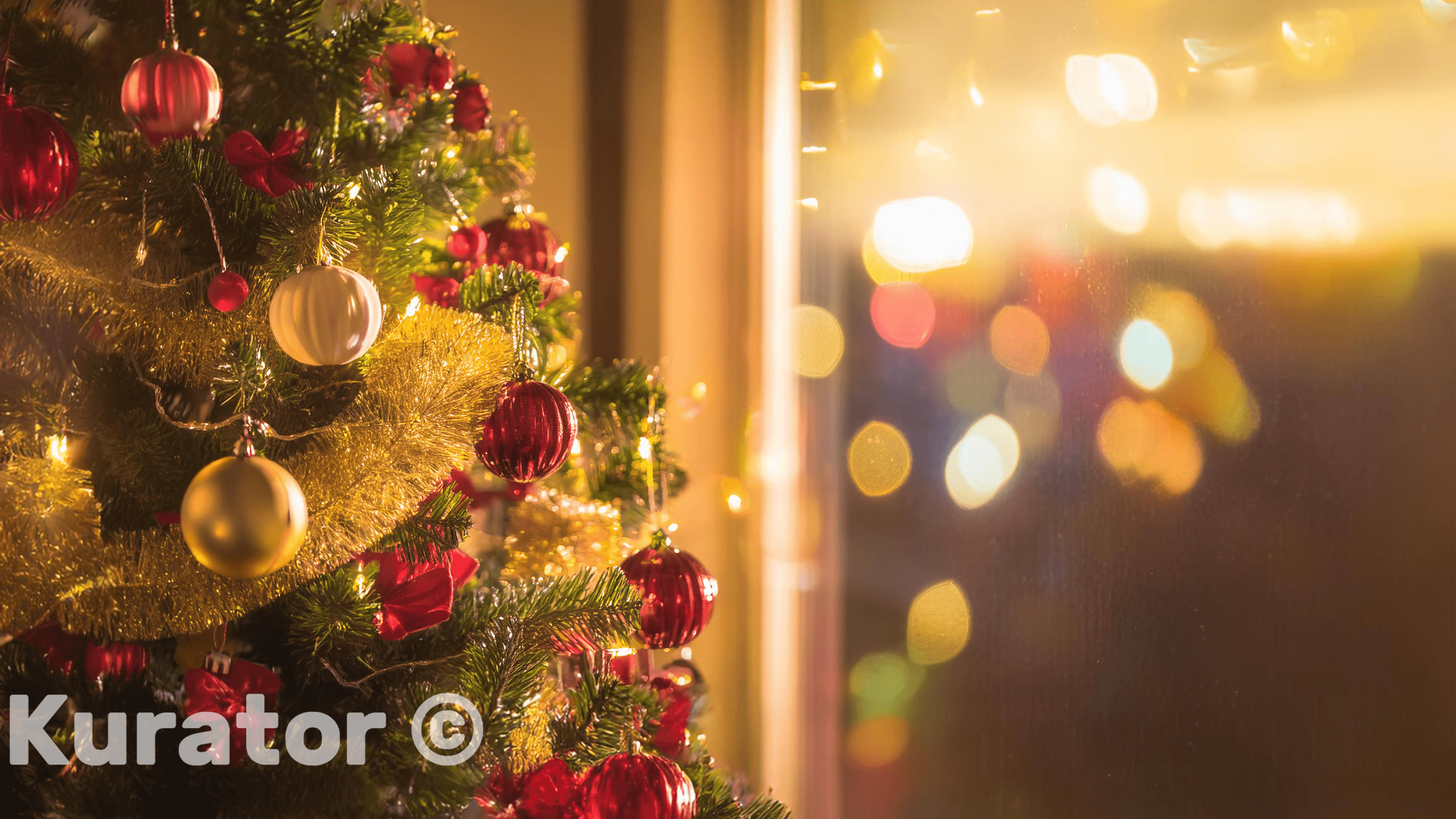 Christmas tree decorated with red and gold ornaments, tinsel, and lights. The background features warm bokeh lights, creating a festive and cozy holiday atmosphere