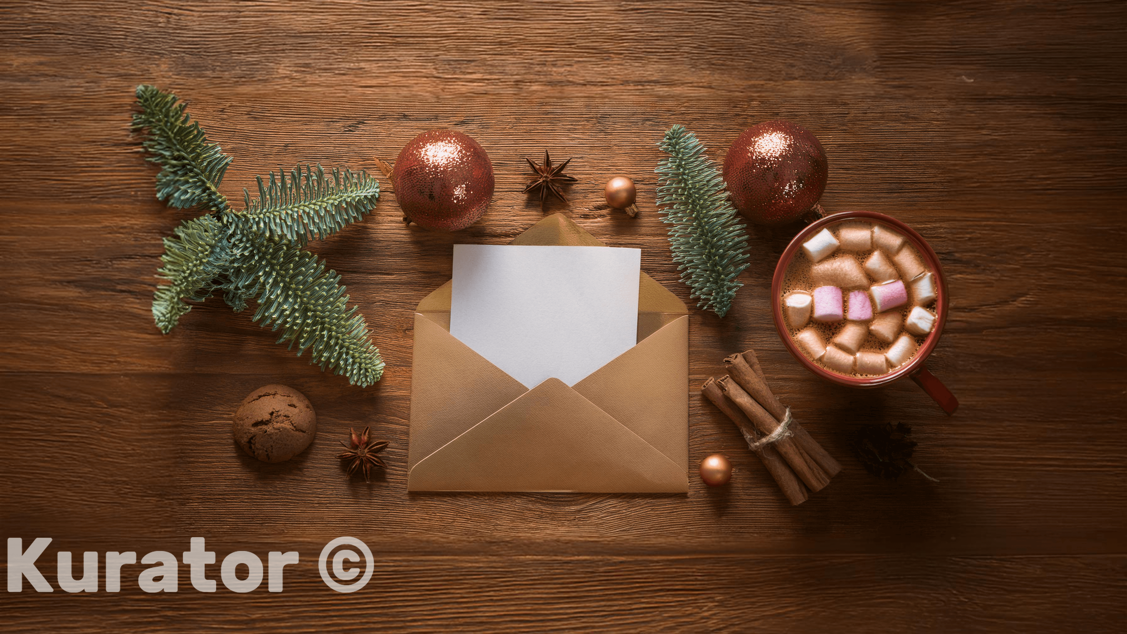 Festive flat lay of a holiday letter in an envelope, surrounded by pine branches, cinnamon sticks, ornaments, a cookie, and a cup of hot chocolate with marshmallows. The warm wooden background adds a cozy touch to this Christmas scene